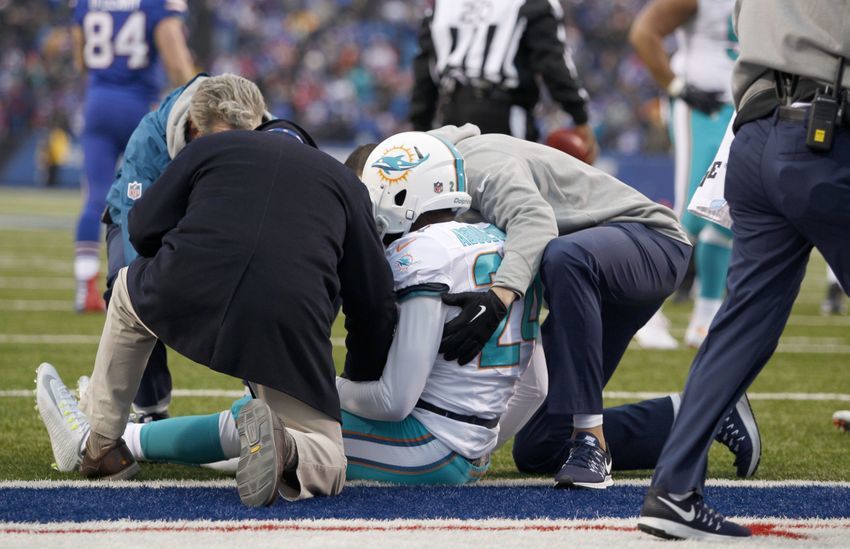 Dec 24, 2016; Orchard Park, NY, USA; Miami Dolphins trainers attend to strong safety Isa Abdul-Quddus (24) during the second half against the Buffalo Bills at New Era Field. Miami beats Buffalo 34 to 31 in overtime. Mandatory Credit: Timothy T. Ludwig-USA TODAY Sports